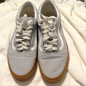 Grey and white vans with a tan gummy sole